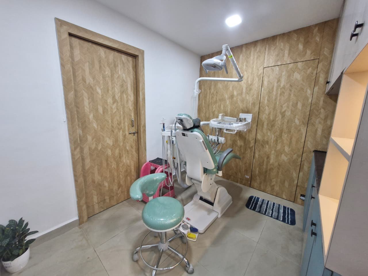 Dental chair suite with wood panel wall and mint chair