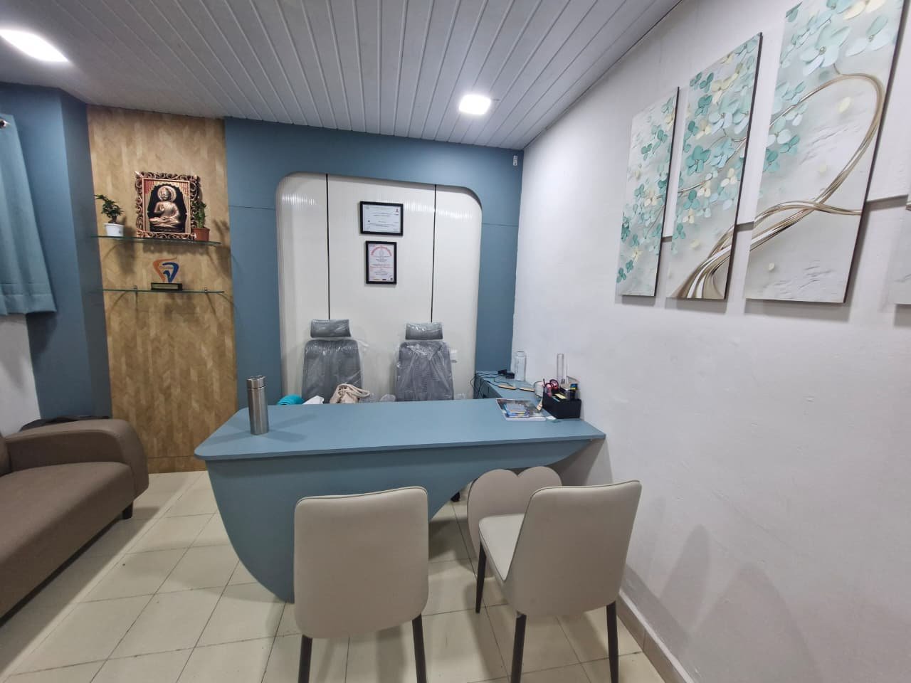 Consultation room at Twinchis Dental Care with blue desk and chairs